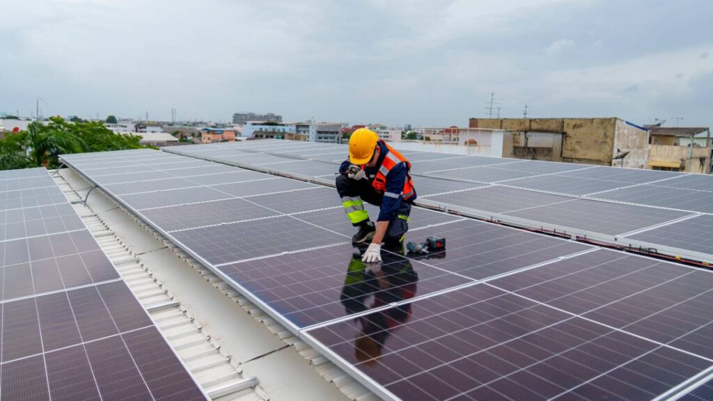 solar panel specialist checking on solar panels laid out on a white roof | SEAI Solar Grant 2026: Your Step-by-Step Claiming Guide